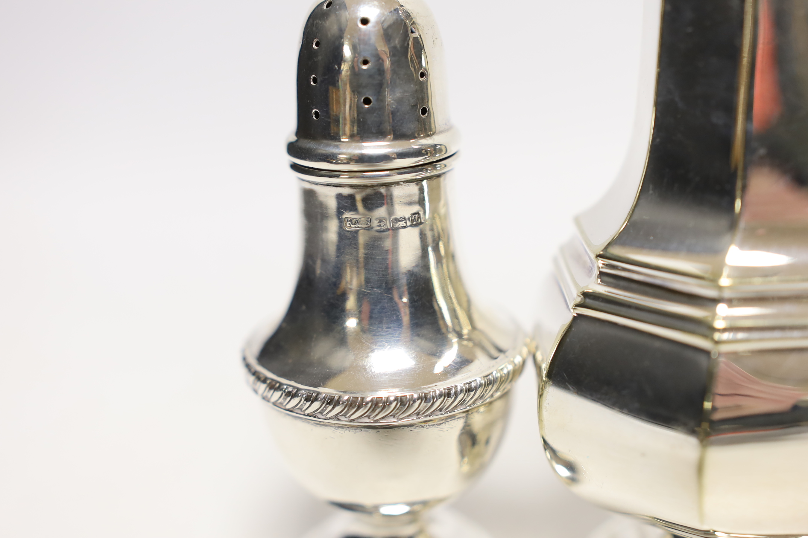 A George V silver pepperette, a silver plated sugar caster and a plated on copper cream jug.